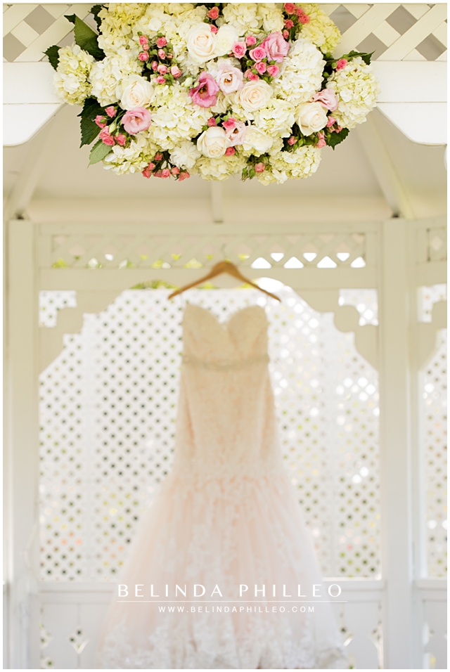 Ceremony florals by Victoria's Garden Anaheim and Blush Mermaid wedding gown
