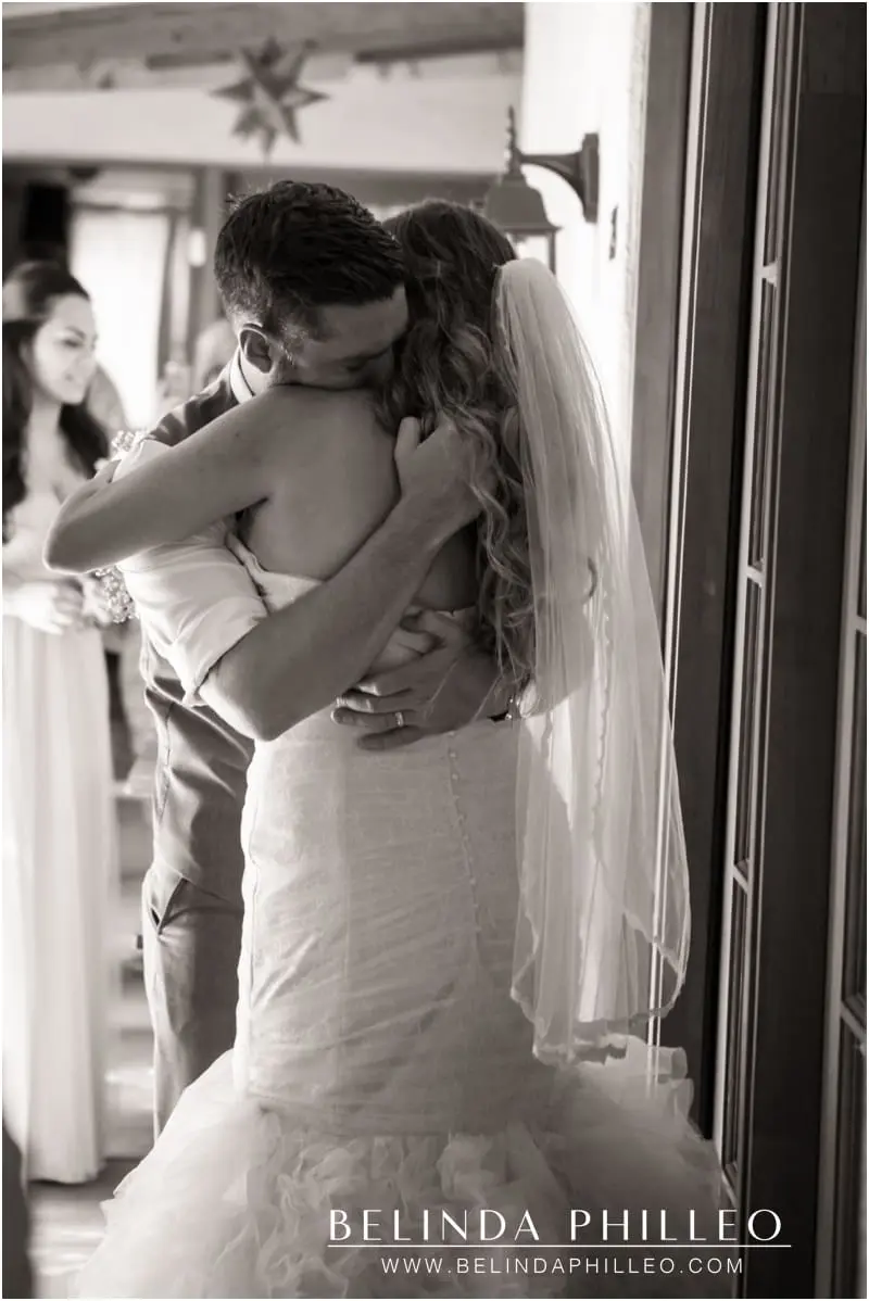 Bride and groom share an emotional hug at their wedding ceremony Casa Cody Inn, Palm Springs, CA