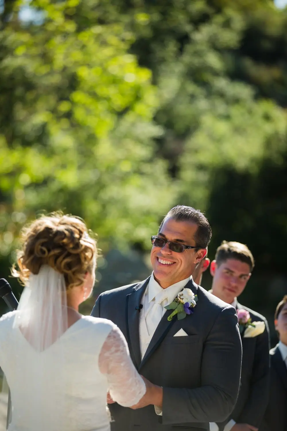 Groom smiles widely at his new bride during their Dove Canyon Golf Club wedding in Orange County, CA