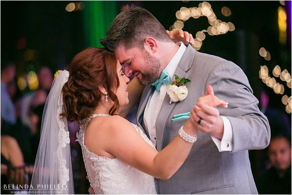 Bride and groom share their first dance at Reef Restaurant wedding reception in Long Beach, CA