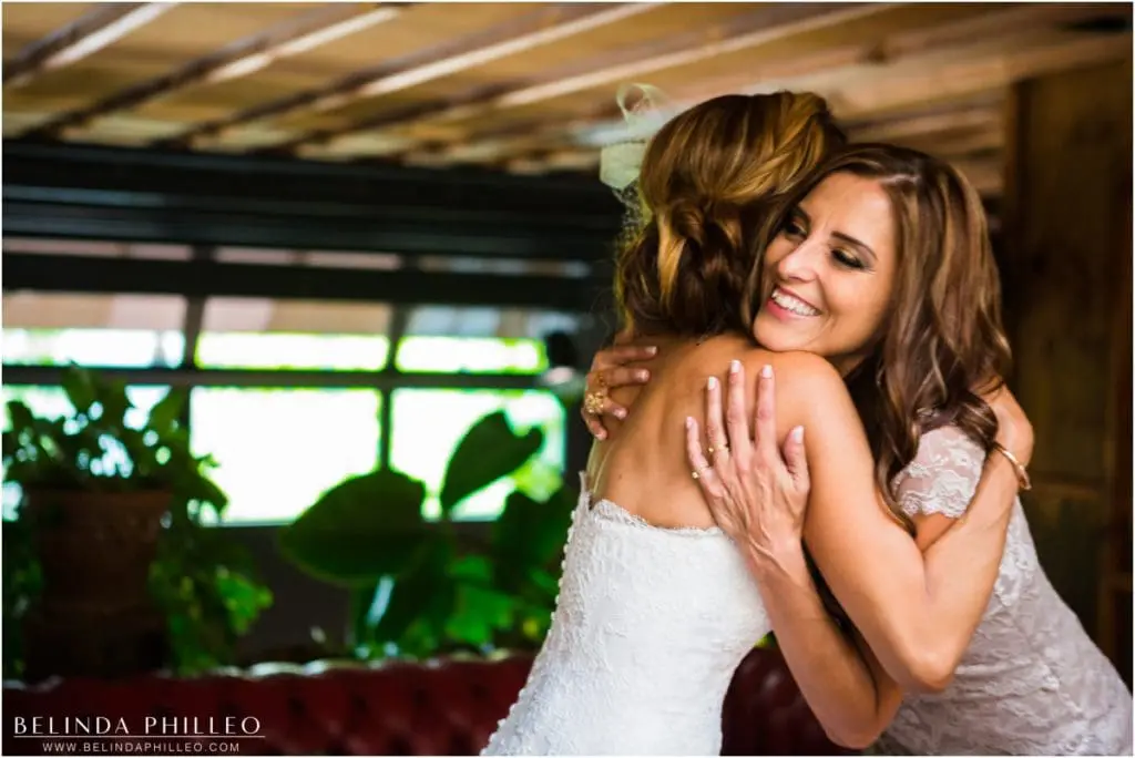 Bride and Maid of Honor share an emotional embrace before the ceremony at Smog Shoppe Los Angeles. Photo by Belinda Philleo