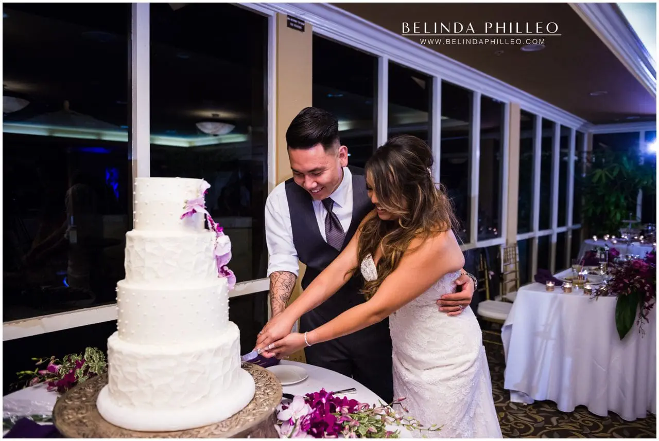 Newlyweds cut the cake at their Friendly Hills Country Club wedding reception in Whittier, CA