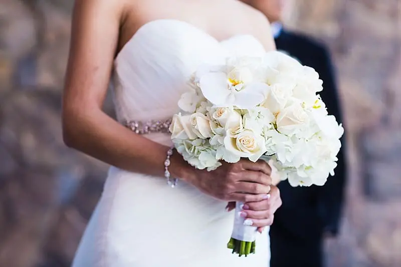 All white bridal bouquet with white hydrangeas, white orchids, and white roses