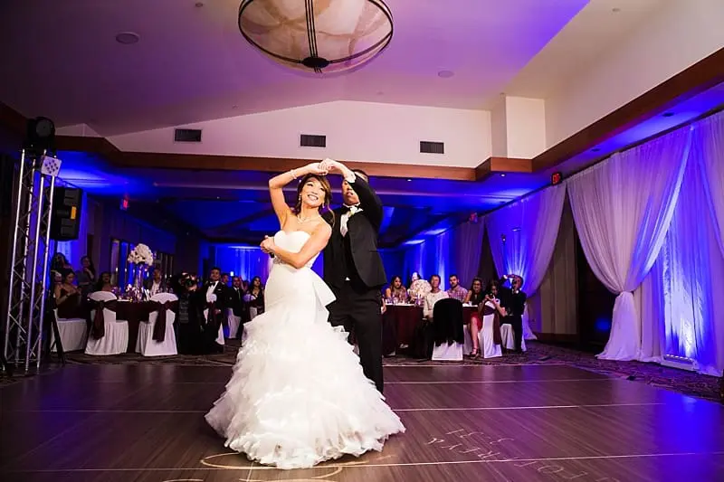 Newlyweds share first dance at Old Ranch Country Club wedding reception in Seal Beach, CA