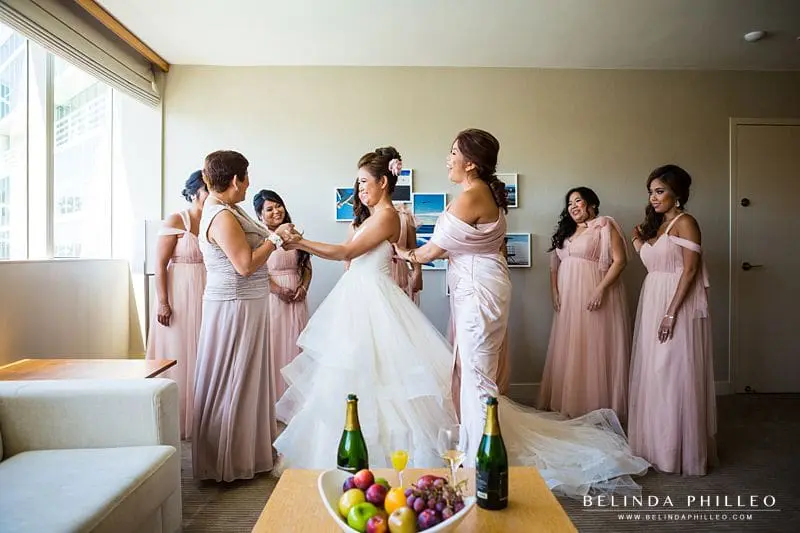 Bridesmaid's help the bride get ready for her wedding at the Hyatt Regency Long Beach, CA