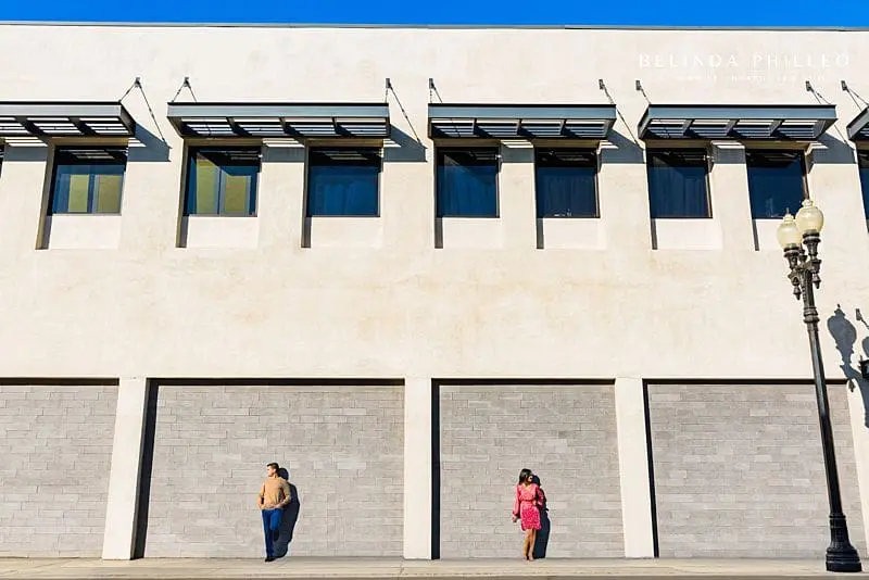 Engaged couple poses dramatically for an edgy and creative engagement session in Downtown Santa Ana