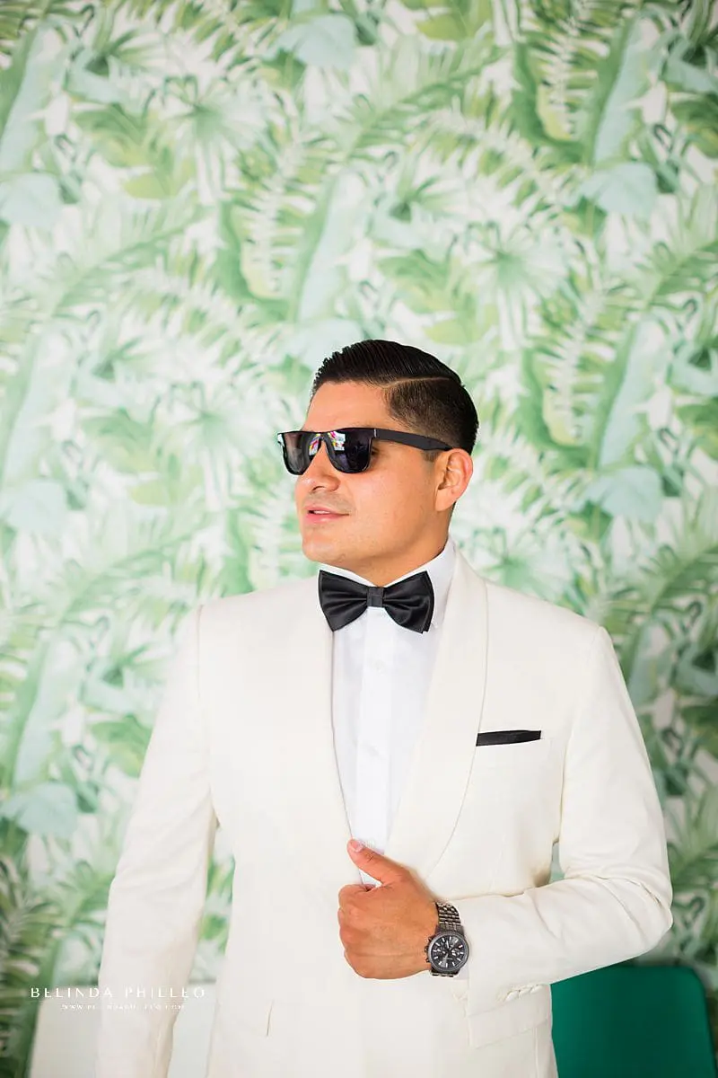 Custom white tux and black bowtie for groom at his Los Angeles Wedding. Photography by Belinda Philleo