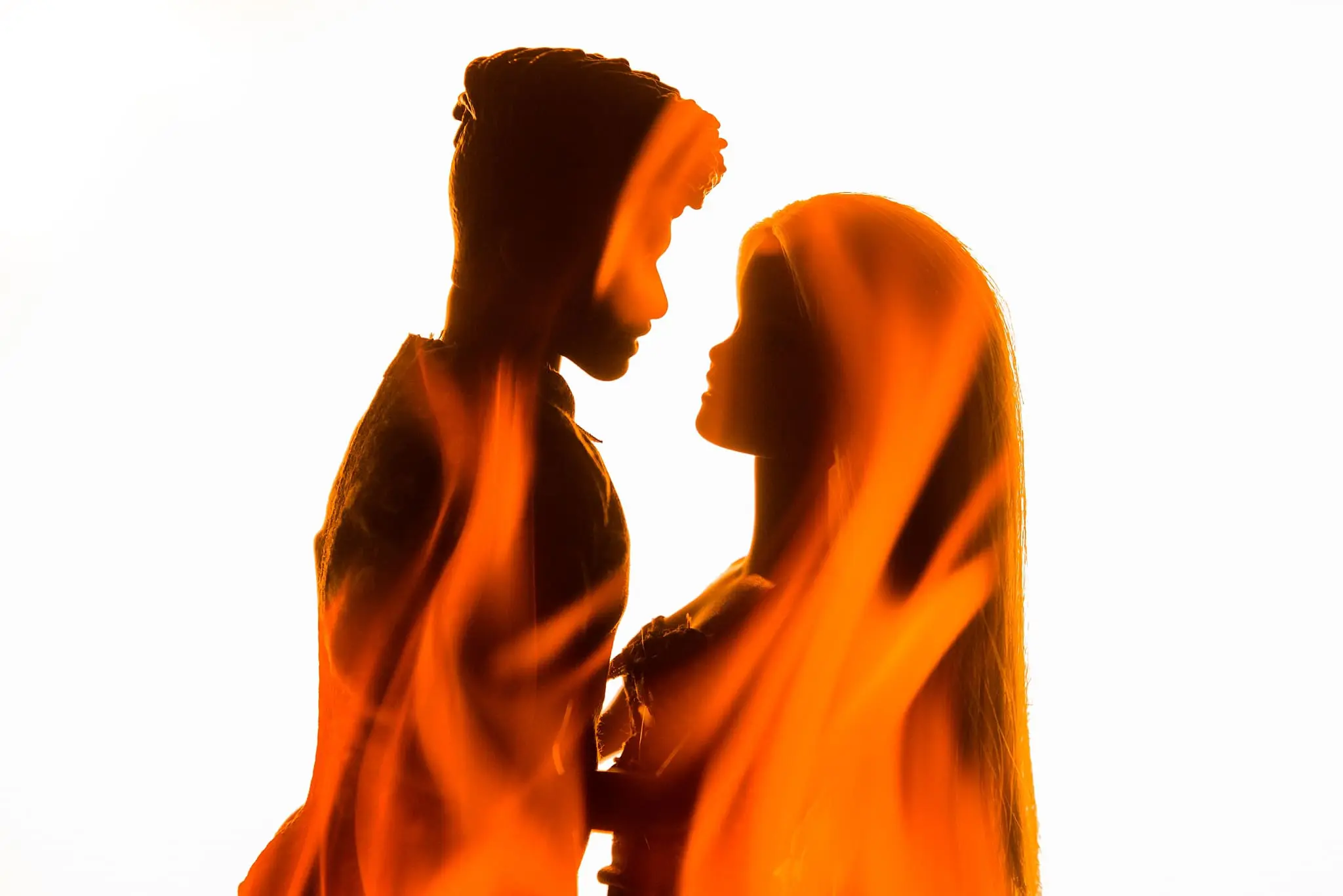 Double exposure of Barbie and Ken with flames