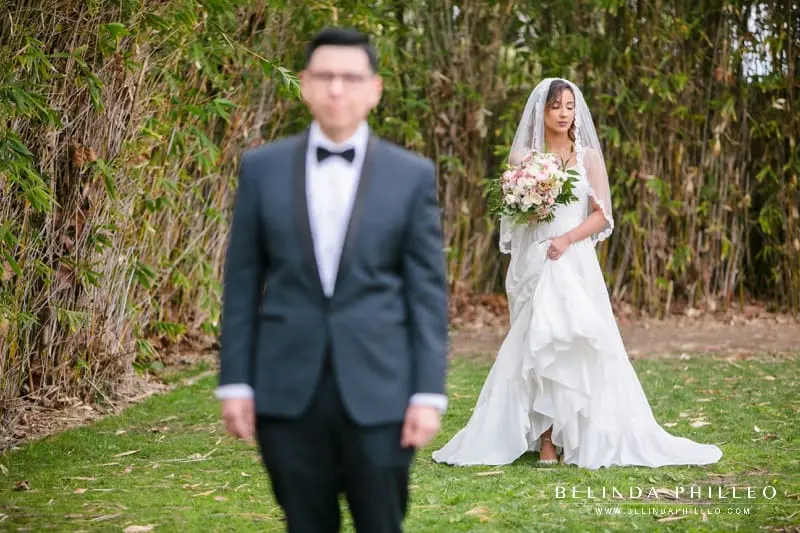 Bride wearing Justin Alexander dress about to have first look with her groom