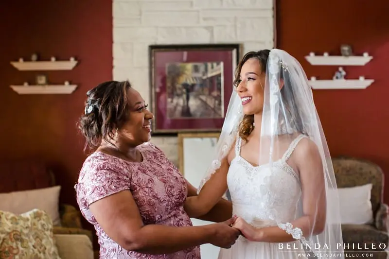 Mother admires bride on her wedding day