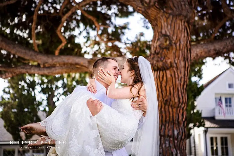 Groom carries his new bride after their Newport Beach elopement