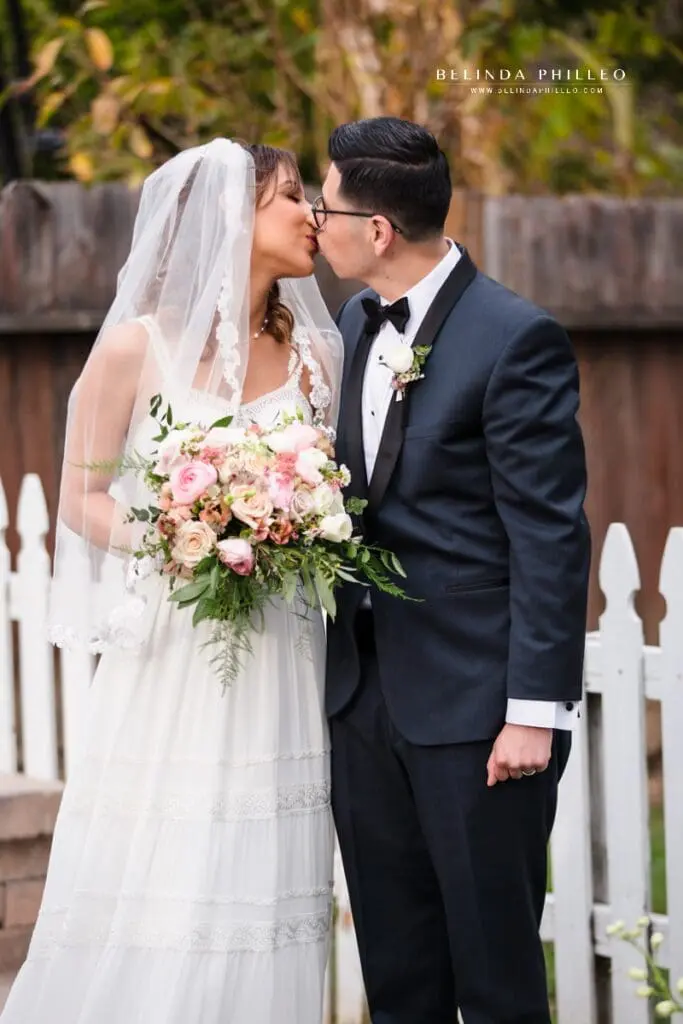 Newlyweds share first kiss during their backyard wedding in Orange County, CA