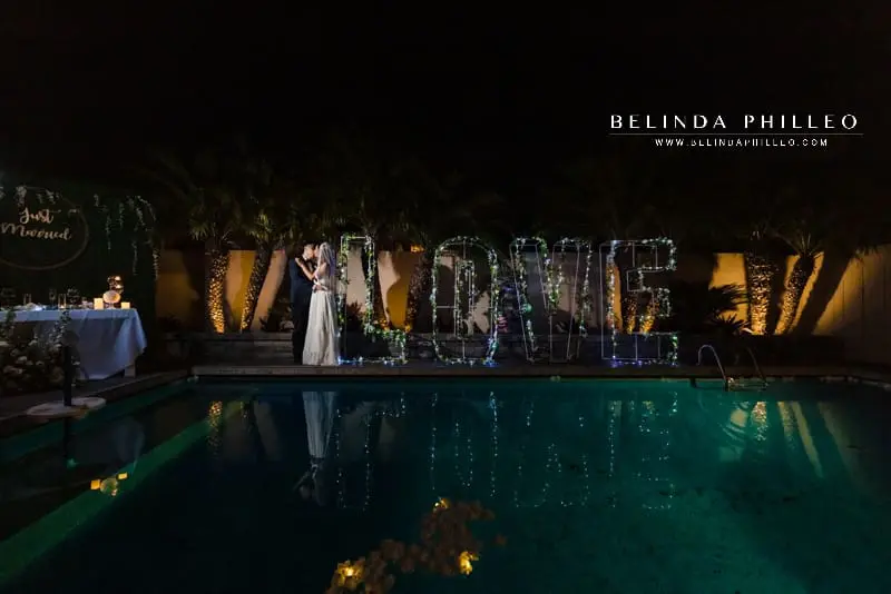 Giant light up love marquee with florals at backyard wedding reception in Orange County, CA 