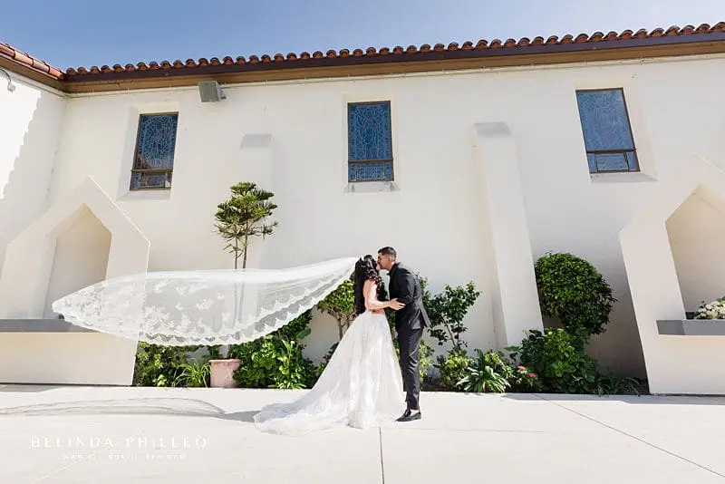 Bride's view flows in the wind at Westminster wedding in Southern California. Photo by Belinda Philleo