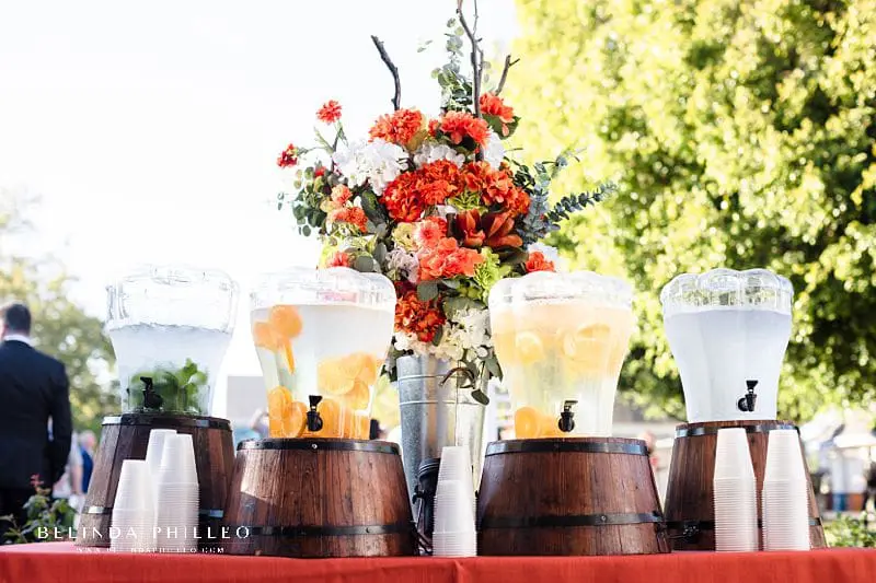 Flavored water station during cocktail hour at a summer wedding