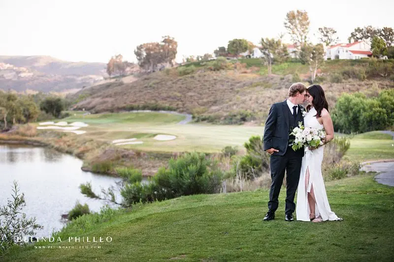 Bride and groom share a quiet moment enjoying the view at their Strawberry Farms Golf Club wedding celebration