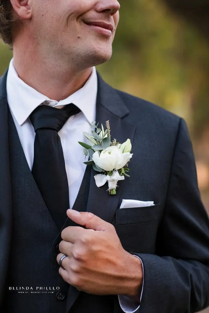 White ranunculus groom boutonnière by Third and Park florist