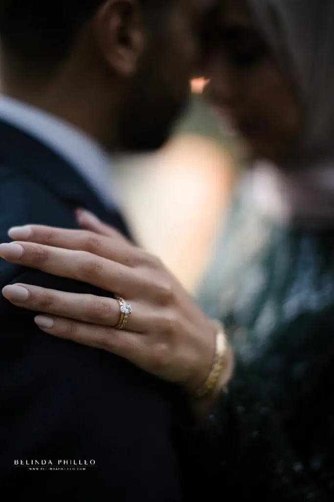 Closeup of gold engagement ring with oval diamond