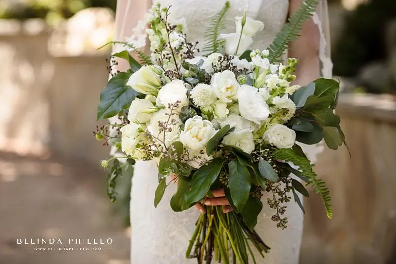 All white bridal bouquet with lush green and fern accents