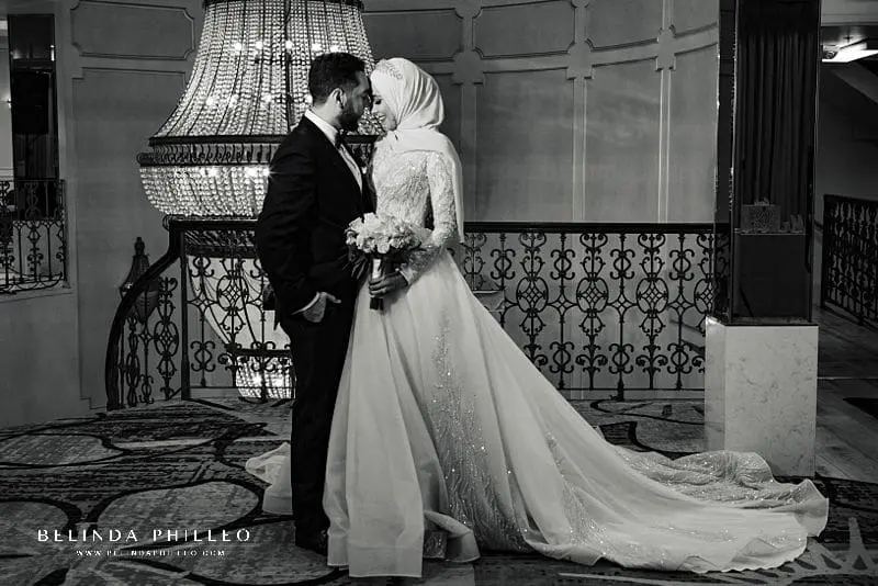 Newlyweds share a quiet moment atop the spiral staircase at Brandview Ballroom wedding.