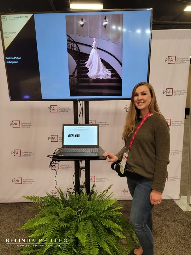 Photographer Belinda Philleo stands beside her Merit image "Anticipation" at the International Photographic Competition Exhibit Imaging USA in Nashville, TN. 2023