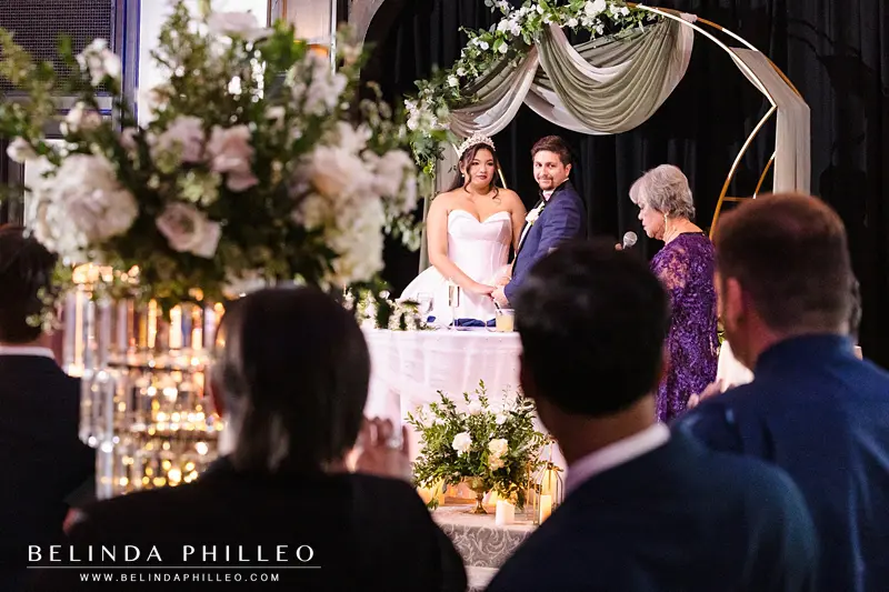 Bride's grandmother makes a speech as wedding guests look on
