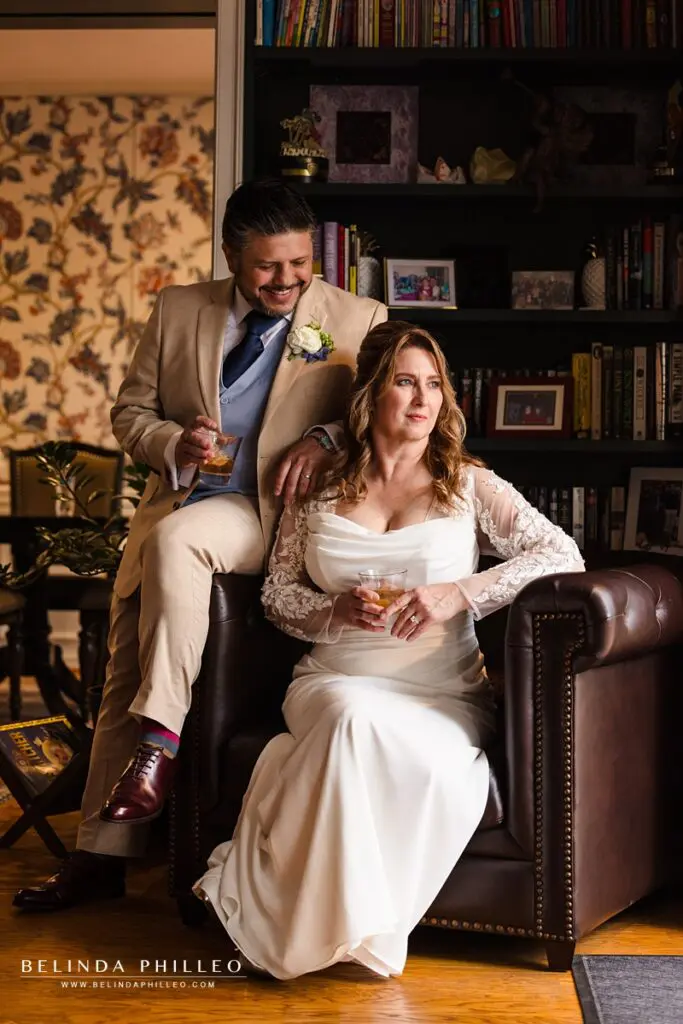 Man and a woman sitting on a leather chair enjoying cocktails