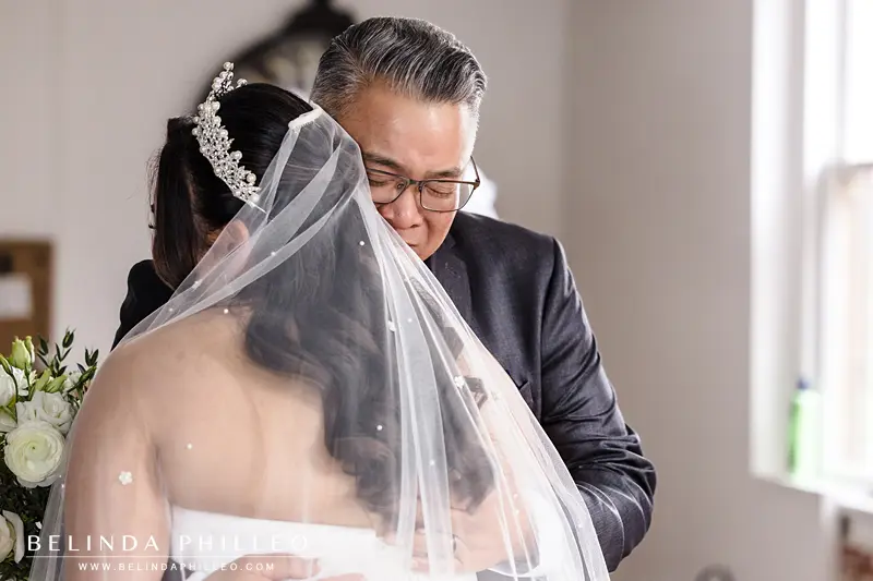 Emotional Father hugs the bride before her wedding ceremony