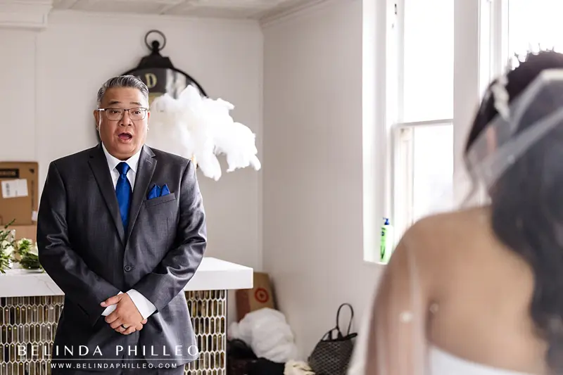 A father reacts, shocked and delighted, to seeing his daughter as a bride 