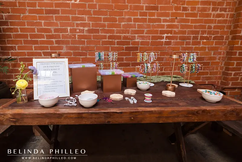 Friendship bracelet making station for cocktail hour and reception guests 