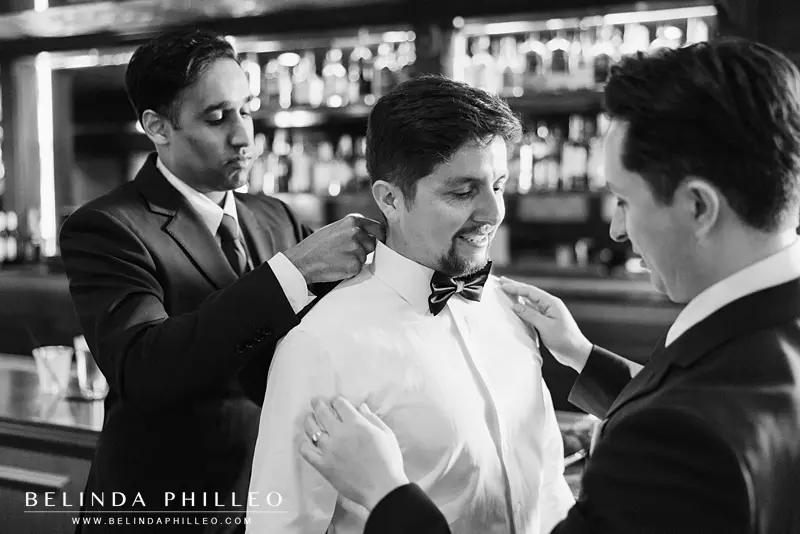Groomsmen help the groom get ready in the Foxtrot Lounge at The Charleston in Downtown Fullerton