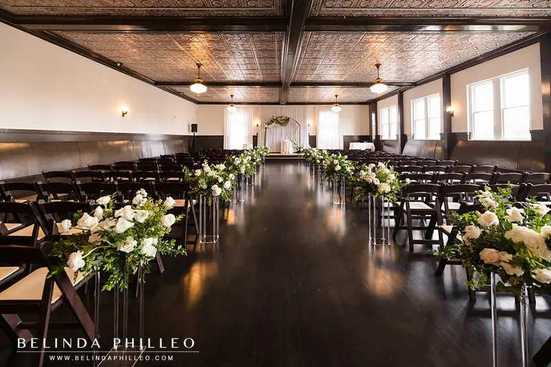 The Petite Ballroom at The Charleston is decorated with white flowers before a wedding ceremony in Fullerton, CA