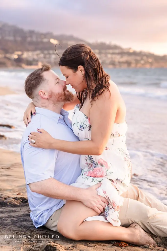 Engaged couple sharing a romantic moment on the beach