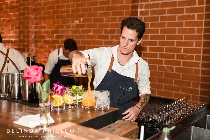The Whaling club bartender pours craft cocktails for wedding guests at Seventh Place Los Angeles wedding reception