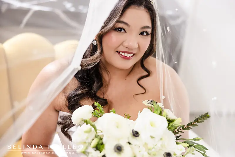 A closeup of the bride smiling underneath her veil