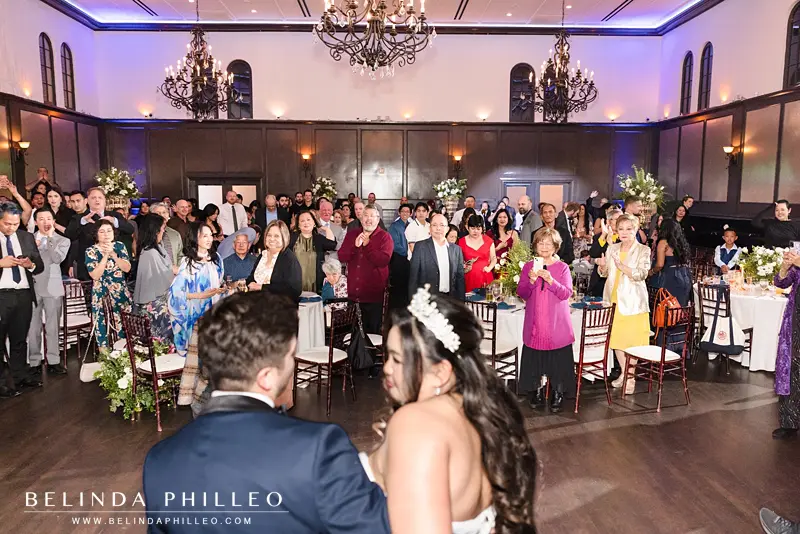 Guests cheer as the newlyweds make their grand entrance
