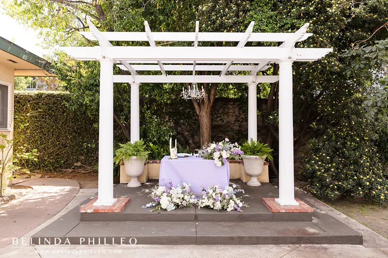 Sweetheart table under a pergola at The French Estate in Orange, CA