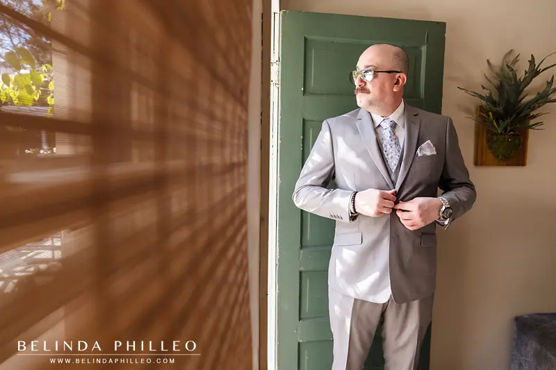 Groom buttoning his jacket in the dressing suite at The French Estate