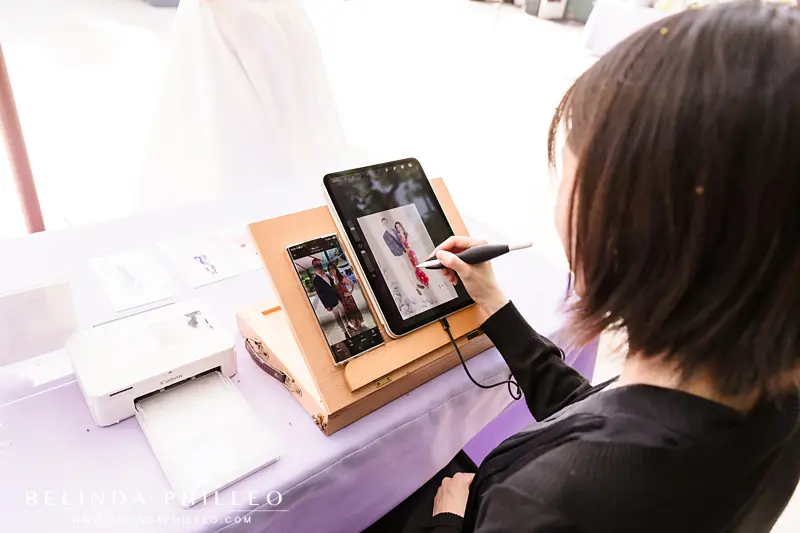 Watercolor artist draws pictures of guests at wedding reception
