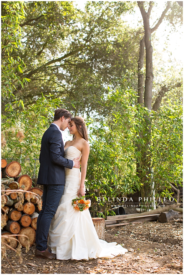 rustic wedding photography. bride and groom sharing a moment near a woodpile