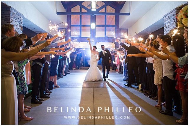 bride and groom exit down a row of guests with sparklers at Alta Vist Country Club wedding