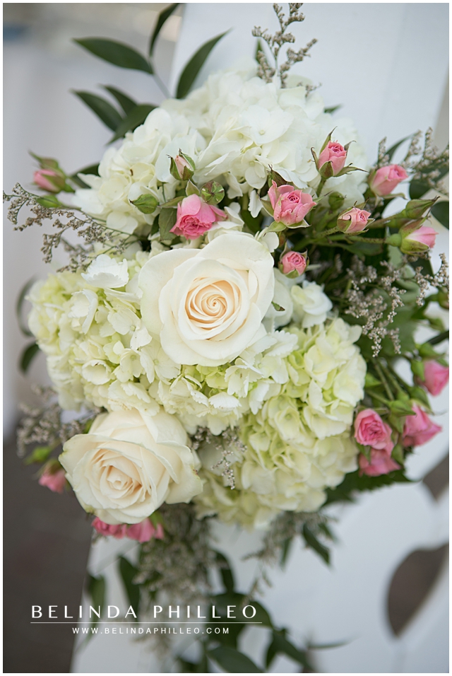 Ceremony Florals with white roses, pink baby roses and hydrangeas created by Victoria's Garden Anaheim