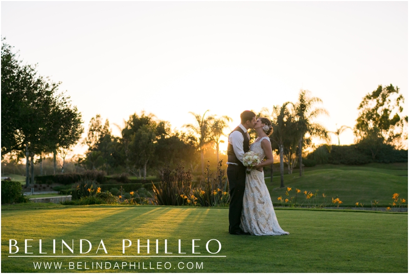 Bride and groom share a kiss during a romantic sunset at Old Ranch Country Club, Seal Beach, CA