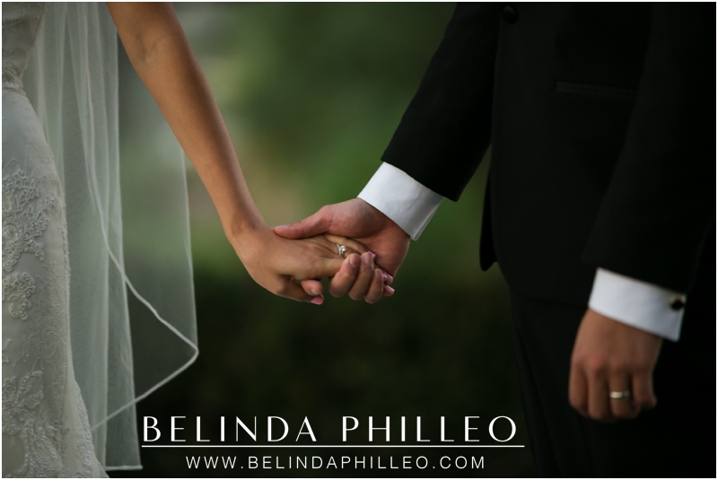 Bride and groom hold hands on their wedding day at Summit House Restaurant, Fullerton, CA