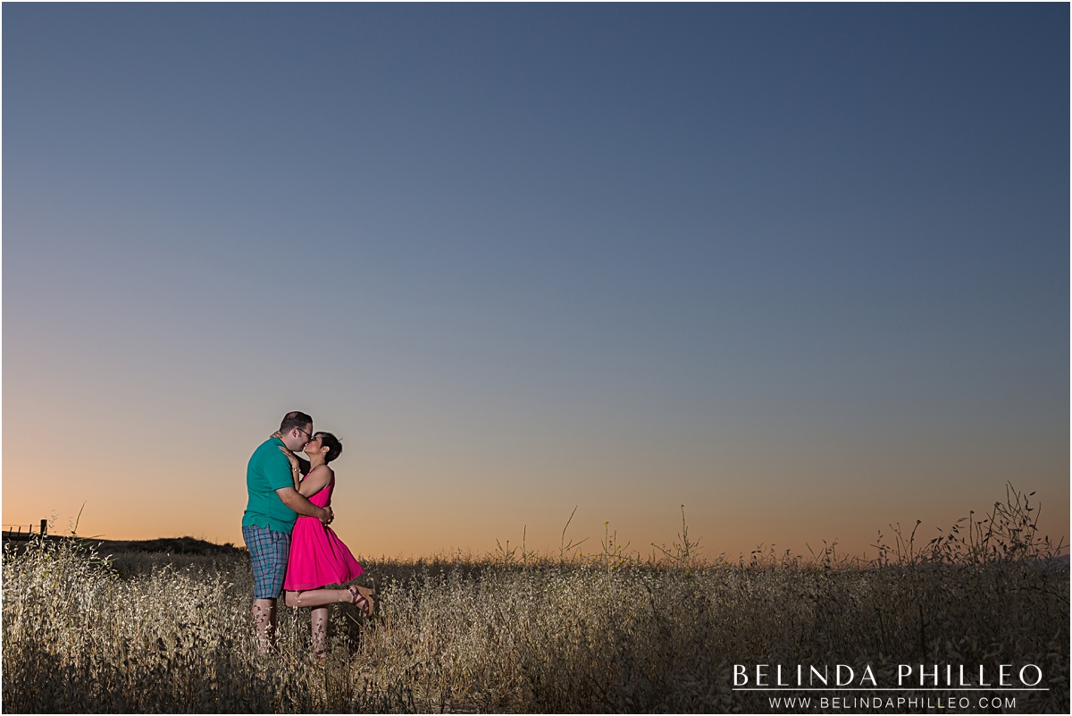 Engaged couple kissing at sunset in Irvine, CA