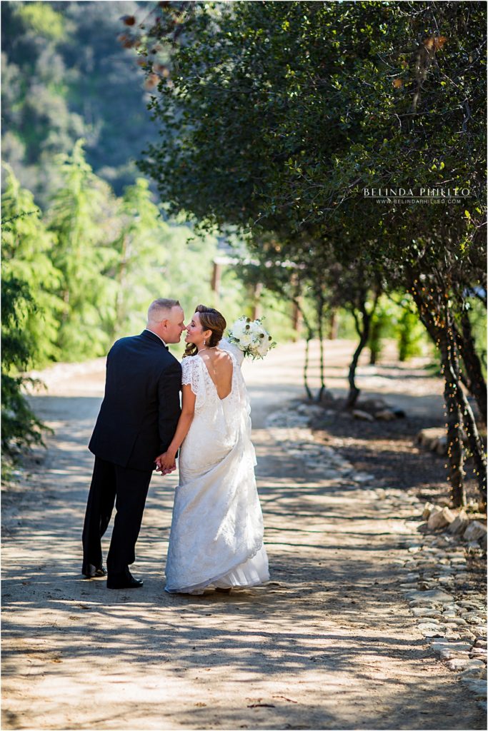 Newlyweds take a stroll in Serendipity Garden wedding venue in Oak Glen, CA