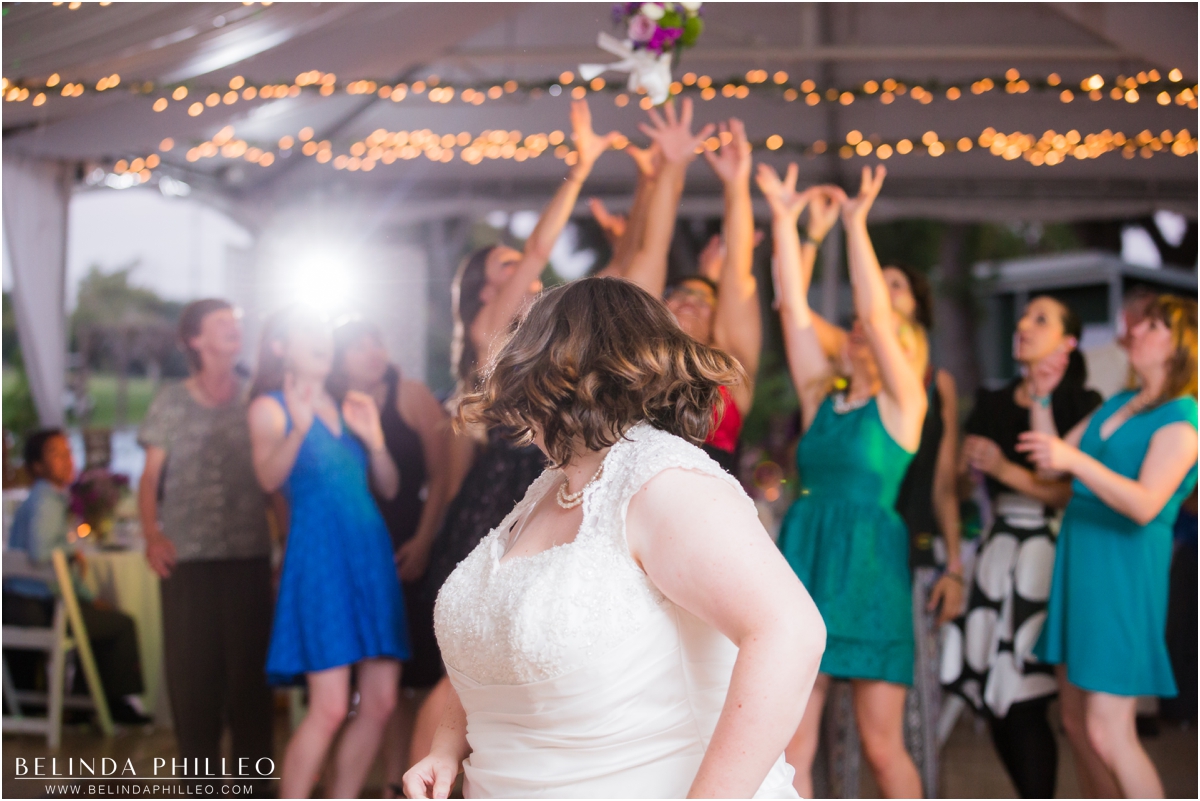 Bride throws bouquet during her tented reception at her El Dorado Park Golf Course wedding in Long Beach, CA