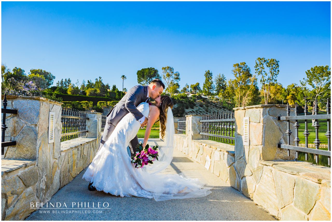 Newlyweds share a kiss on the bridge at Friendly Hills Country Club Wedding, Whittier, CA
