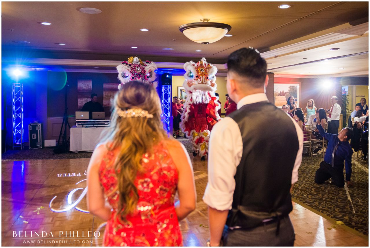 Bride and Groom entertained by Lion Dance at their Friendly Hills Country Club Wedding in Whittier, CA. Photo by Belinda Philleo