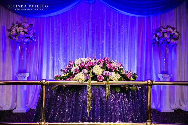 White and purple head table flowers by Creative Celebration Events, Paramount, CA